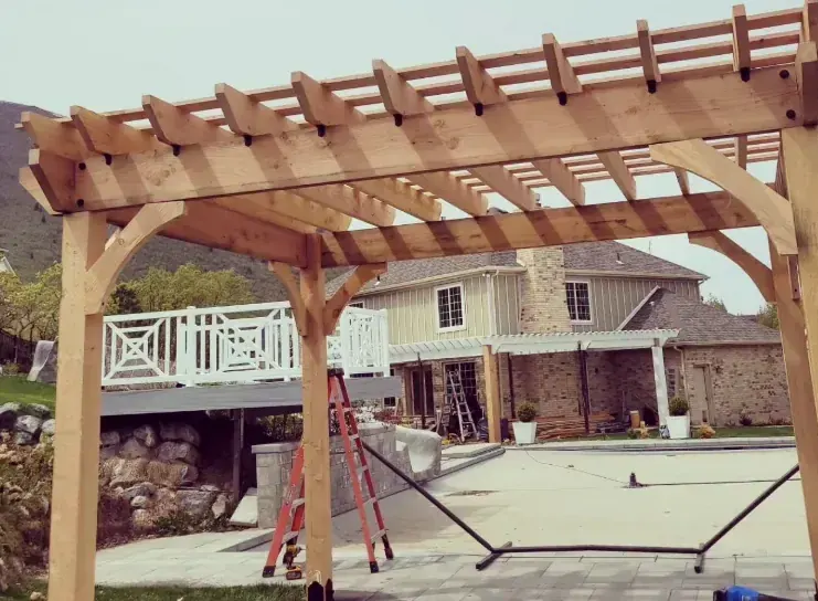 Large cedar pergola over a backyard patio by Frame Platinum LLC