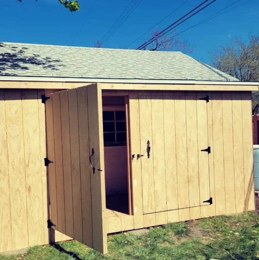 Freshly built shed with open barn-style door by Frame Platinum LLC