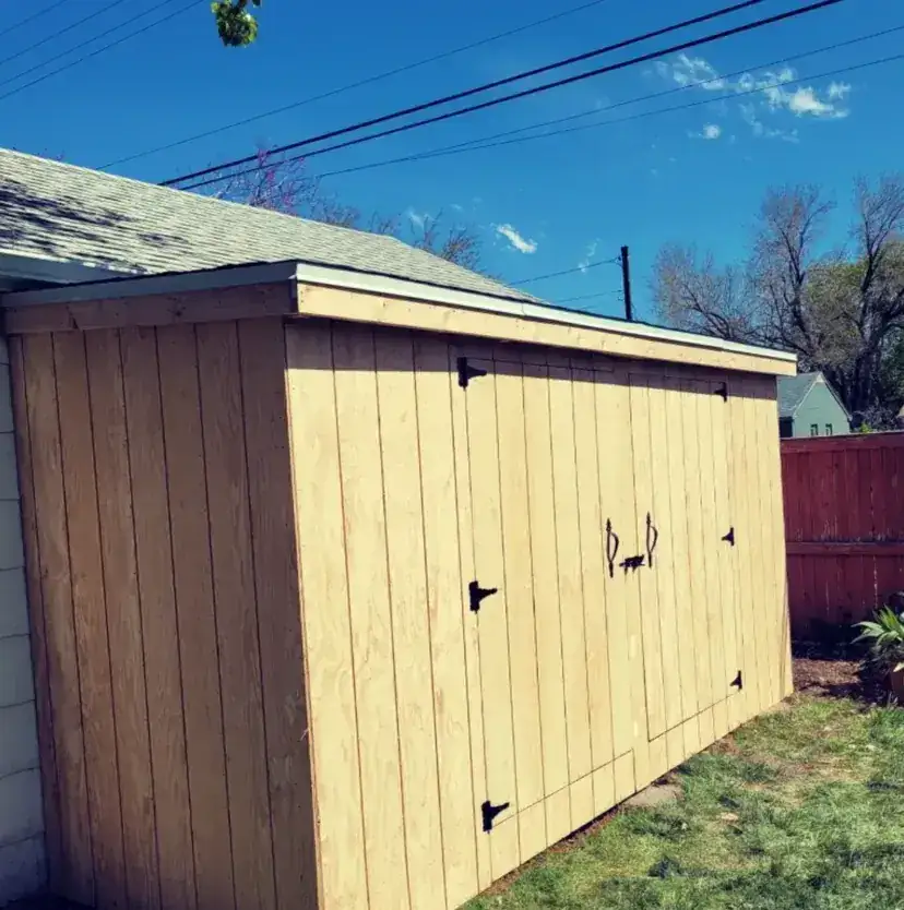 Long side view of a custom shed by Frame Platinum LLC